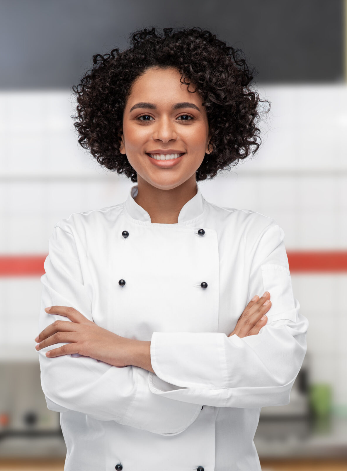 smiling female chef in white jacket on kitchen