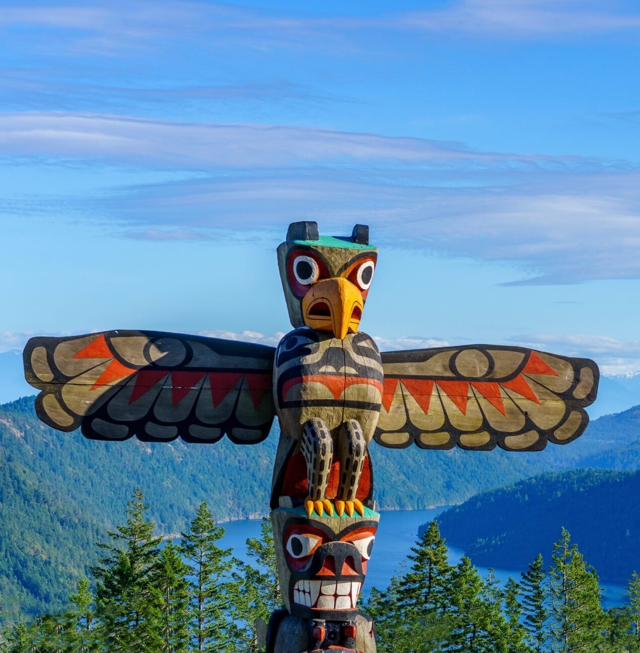Totem pole towers over scenic wilderness and ocean